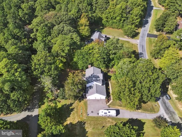 an aerial view of a houses with a lake