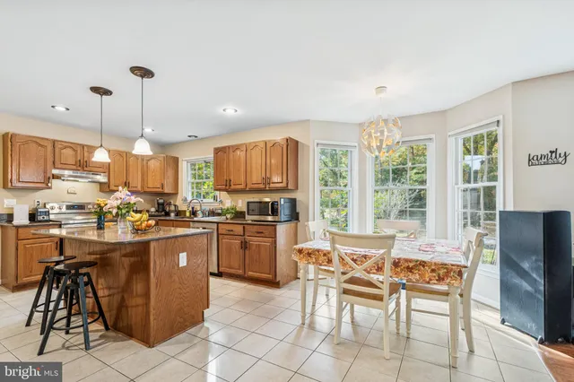a kitchen with a sink a counter and chairs