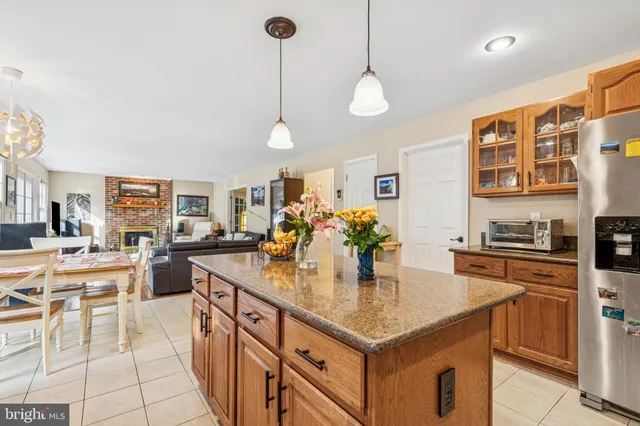 a kitchen with a sink a counter and chairs