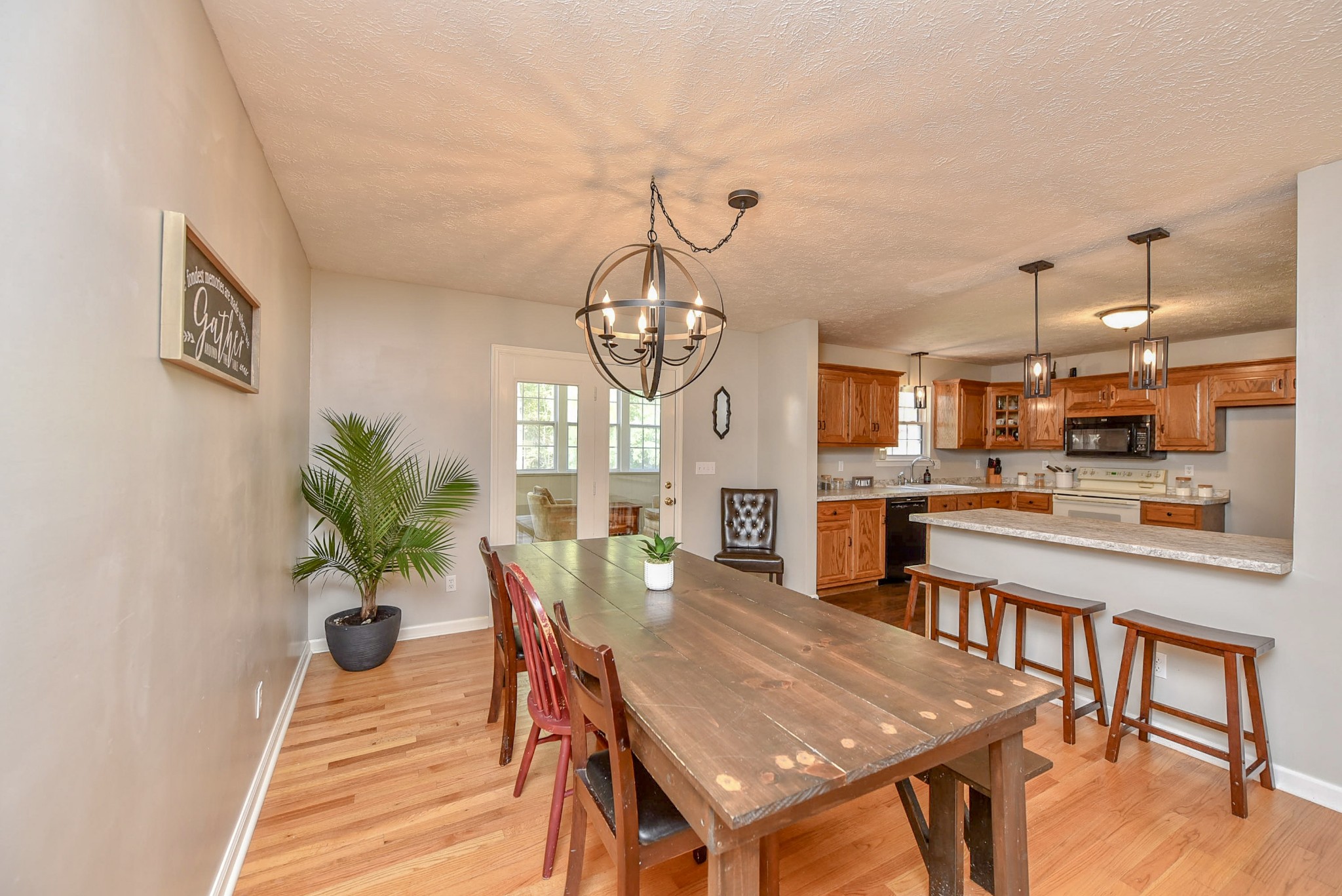 1059 North Corinth Road Portland, TN 37148 - Photo 17 of 40 a dining room with furniture a chandelier and wooden floor