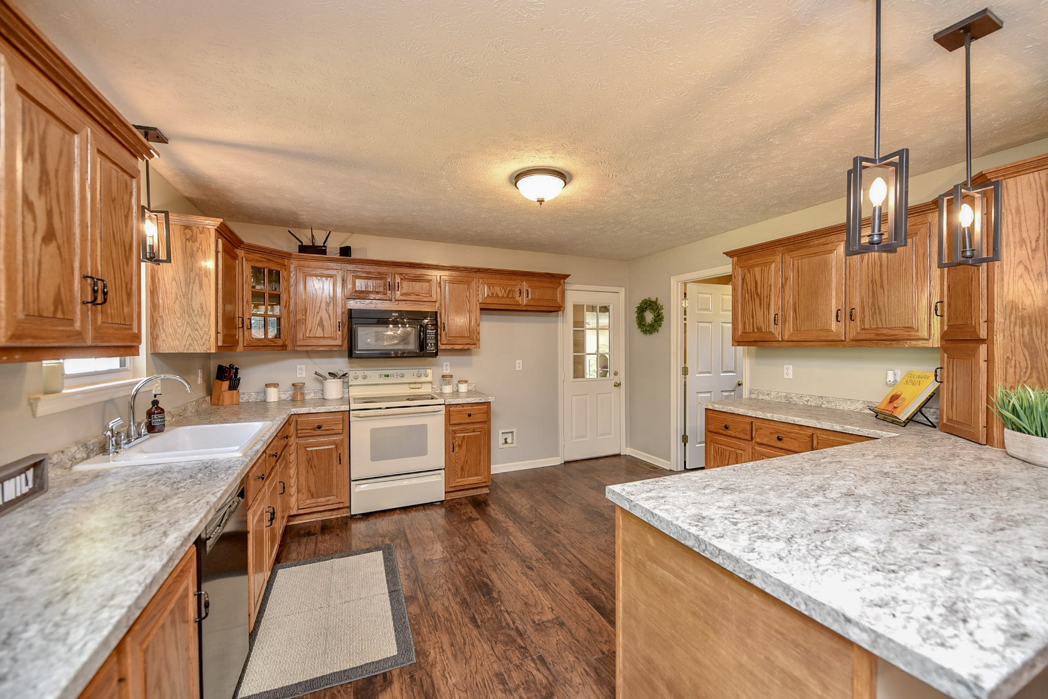 1059 North Corinth Road Portland, TN 37148 - Photo 19 of 40 a kitchen with stainless steel appliances granite countertop a sink stove and refrigerator