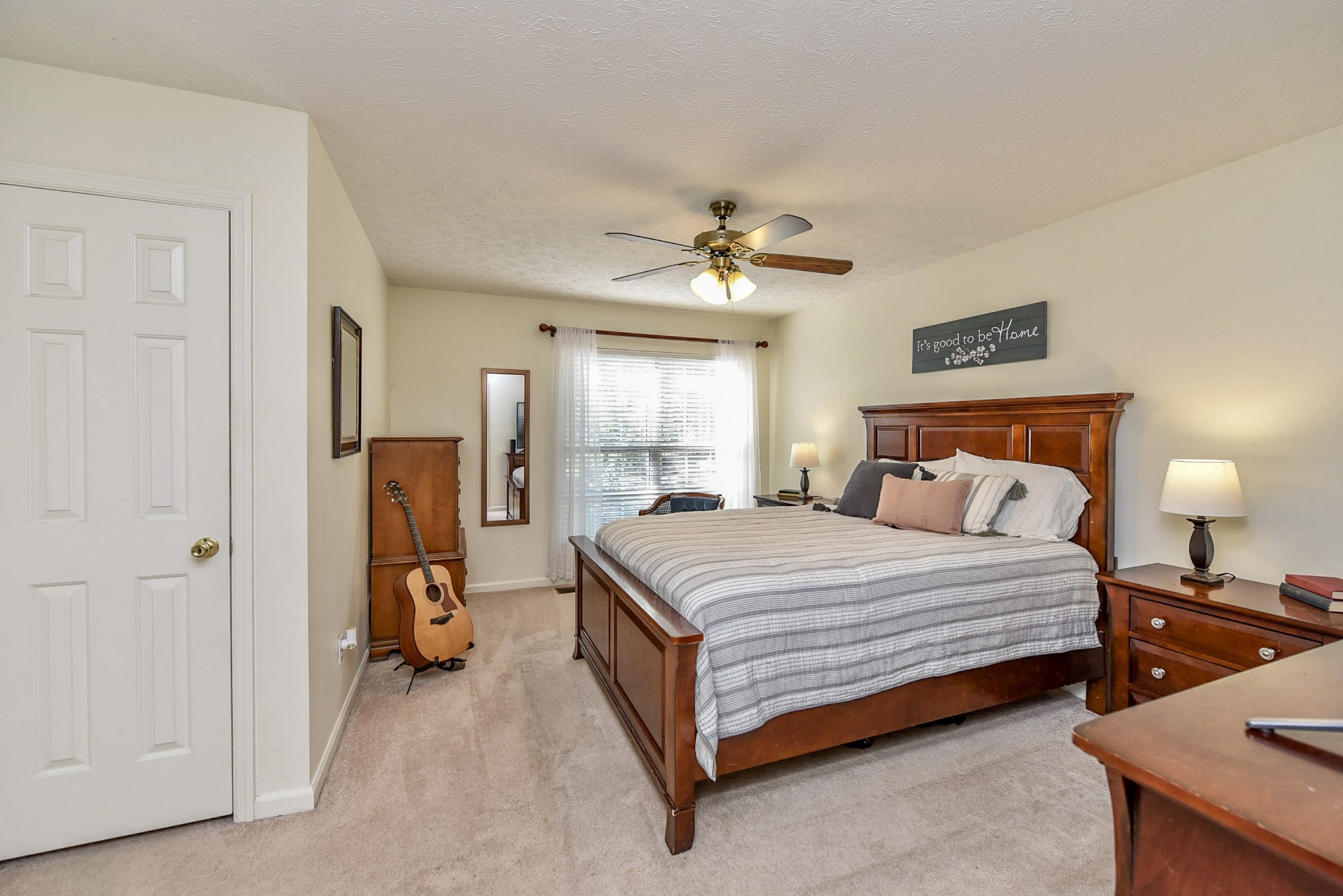 1059 North Corinth Road Portland, TN 37148 - Photo 24 of 40 a spacious bedroom with a bed and a chandelier