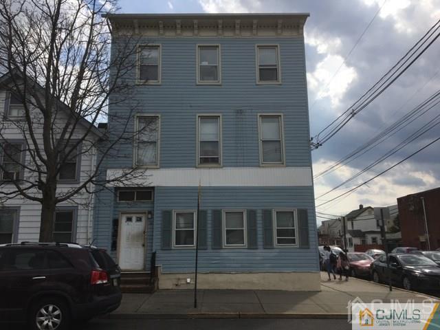 a front view of a building with parking space