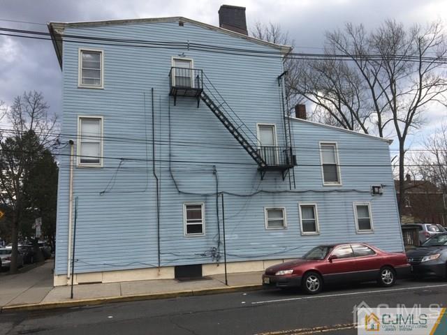 68 Guilden Street New Brunswick, NJ 08901 - Photo 2 of 3 a couple of cars parked in front of a house