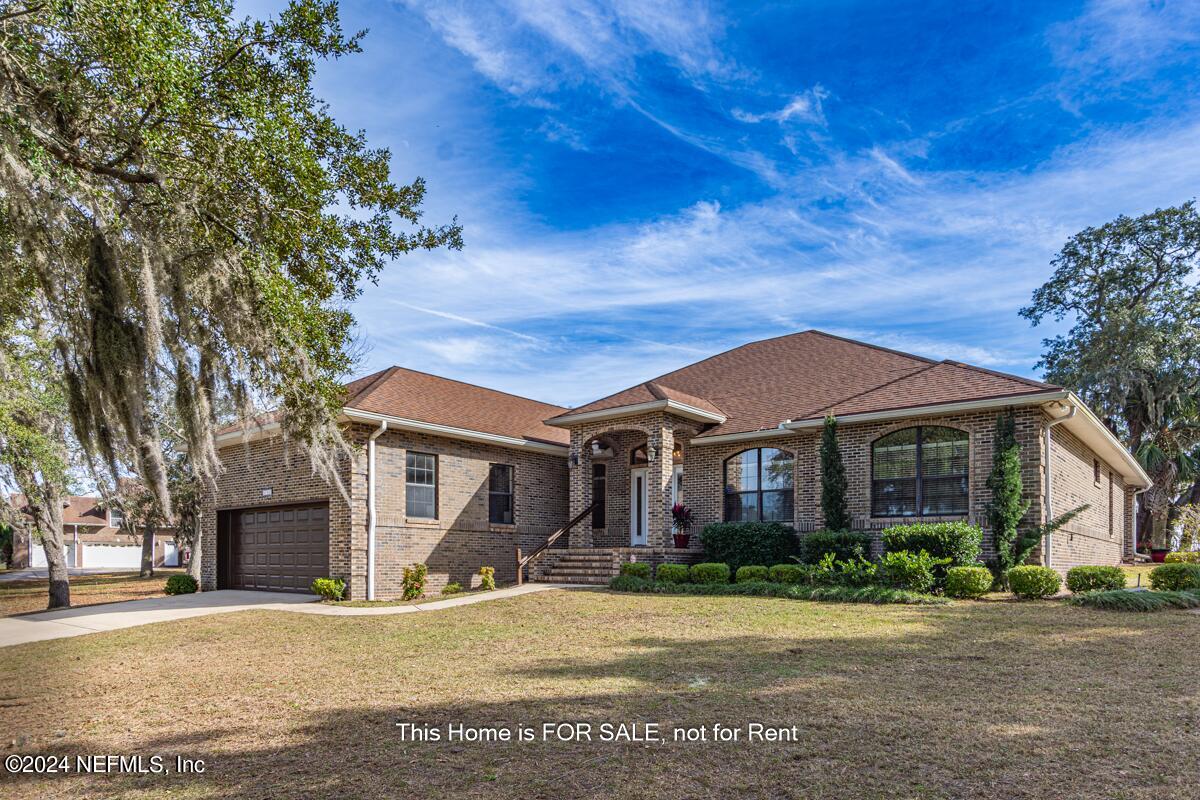 a front view of a house with a garden