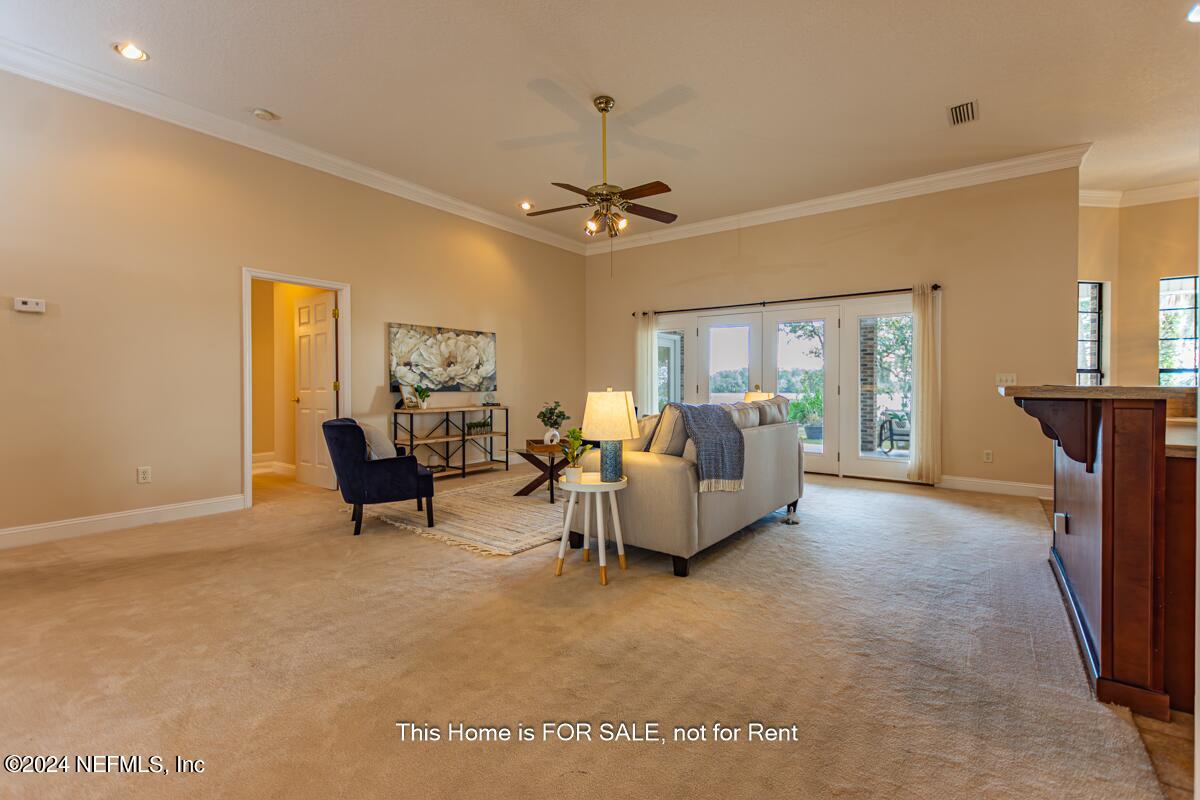 5745 Sheffield Road Jacksonville, FL 32226 - Photo 12 of 57 a living room with furniture and a chandelier