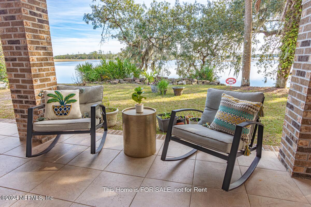 5745 Sheffield Road Jacksonville, FL 32226 - Photo 13 of 57 a view of a patio with table and chairs and potted plants