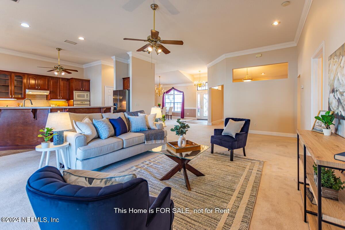 5745 Sheffield Road Jacksonville, FL 32226 - Photo 14 of 57 a living room with furniture a chandelier and a flat screen tv