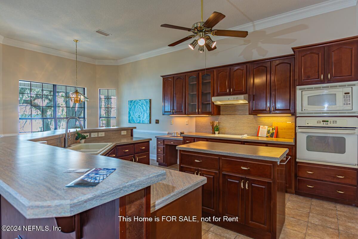 5745 Sheffield Road Jacksonville, FL 32226 - Photo 17 of 57 a kitchen with stainless steel appliances granite countertop a sink a stove and a microwave