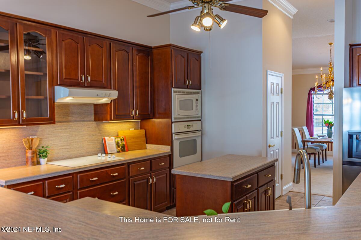 5745 Sheffield Road Jacksonville, FL 32226 - Photo 18 of 57 a kitchen with stainless steel appliances granite countertop wooden cabinets a refrigerator and a stove