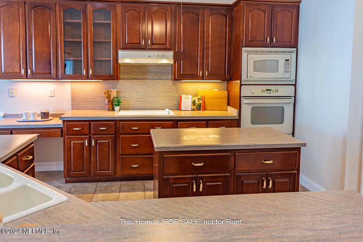 5745 Sheffield Road Jacksonville, FL 32226 - Photo 19 of 57 a kitchen with stainless steel appliances granite countertop a stove and a cabinets