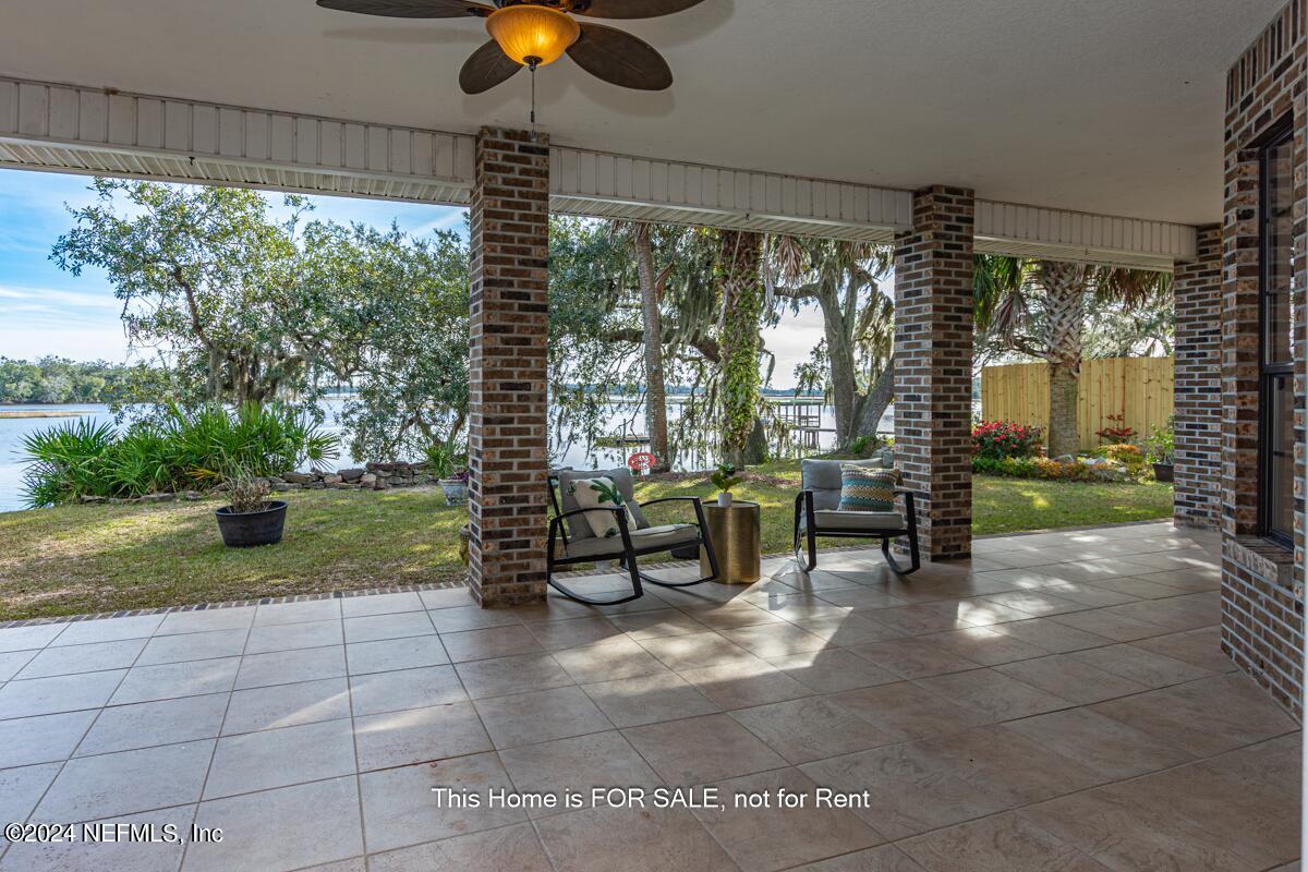 5745 Sheffield Road Jacksonville, FL 32226 - Photo 27 of 57 a view of a porch with a table and chairs