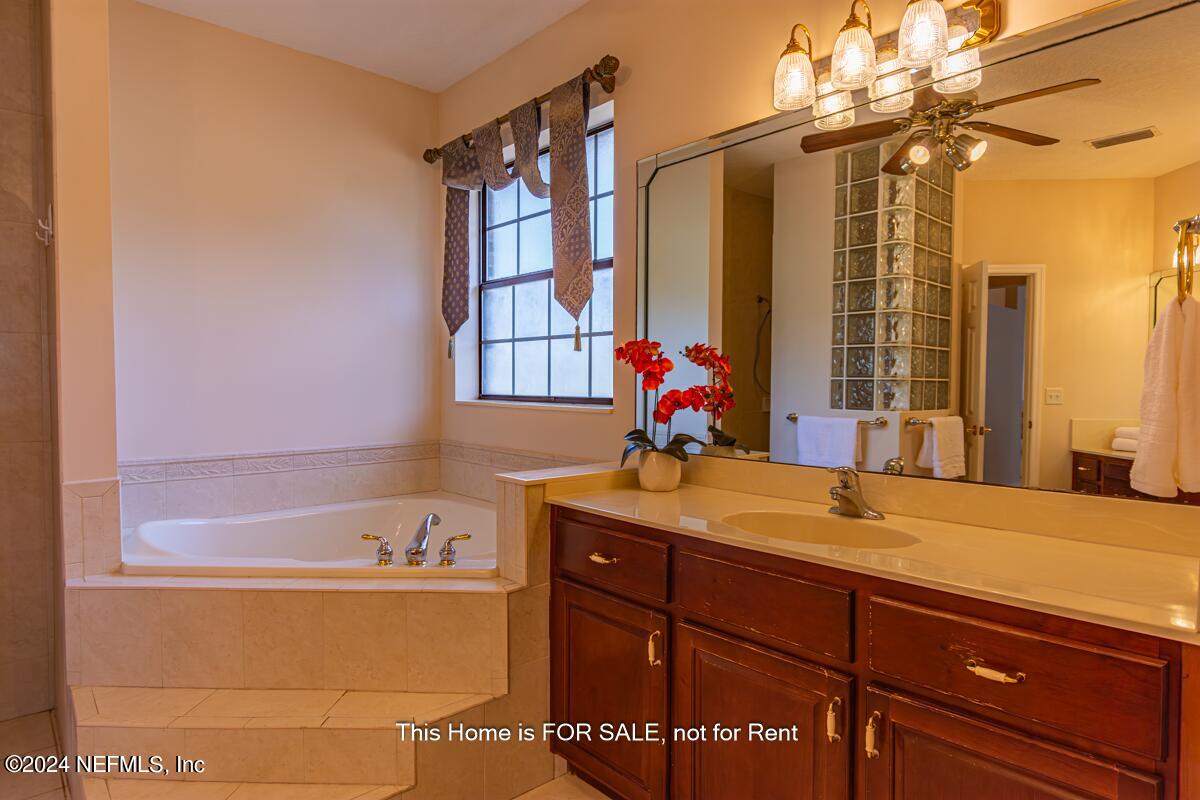5745 Sheffield Road Jacksonville, FL 32226 - Photo 28 of 57 a bathroom with a tub sink and mirror