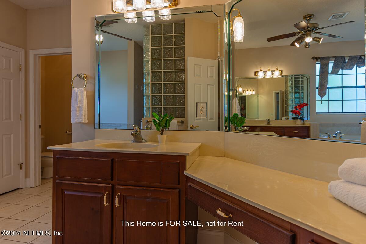 5745 Sheffield Road Jacksonville, FL 32226 - Photo 30 of 57 a bathroom with a sink and a mirror
