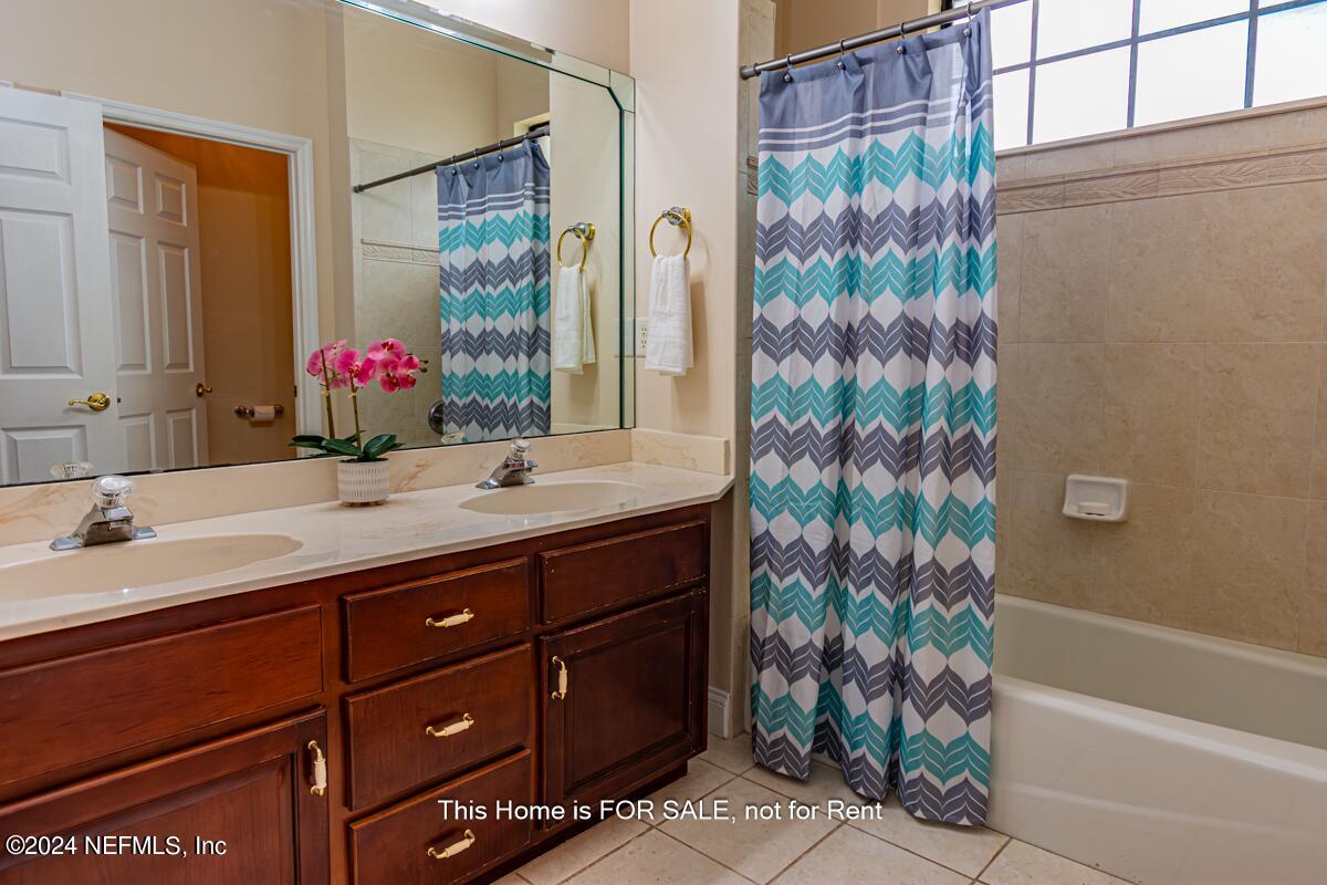 5745 Sheffield Road Jacksonville, FL 32226 - Photo 37 of 57 a bathroom with a granite countertop sink and a mirror