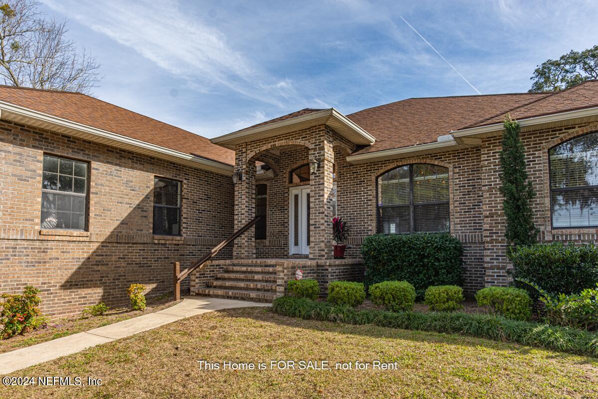 5745 Sheffield Road Jacksonville, FL 32226 - Photo 4 of 57 a front view of a house with garden
