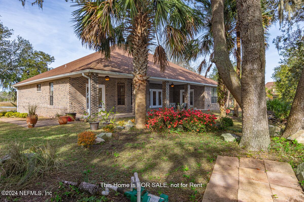 5745 Sheffield Road Jacksonville, FL 32226 - Photo 49 of 57 a front view of house with yard and trees around