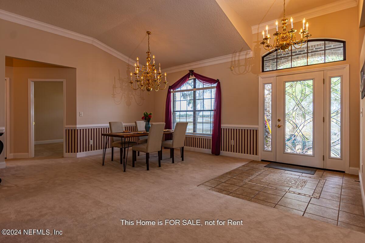 5745 Sheffield Road Jacksonville, FL 32226 - Photo 8 of 57 a view of a dining room with furniture and a chandelier