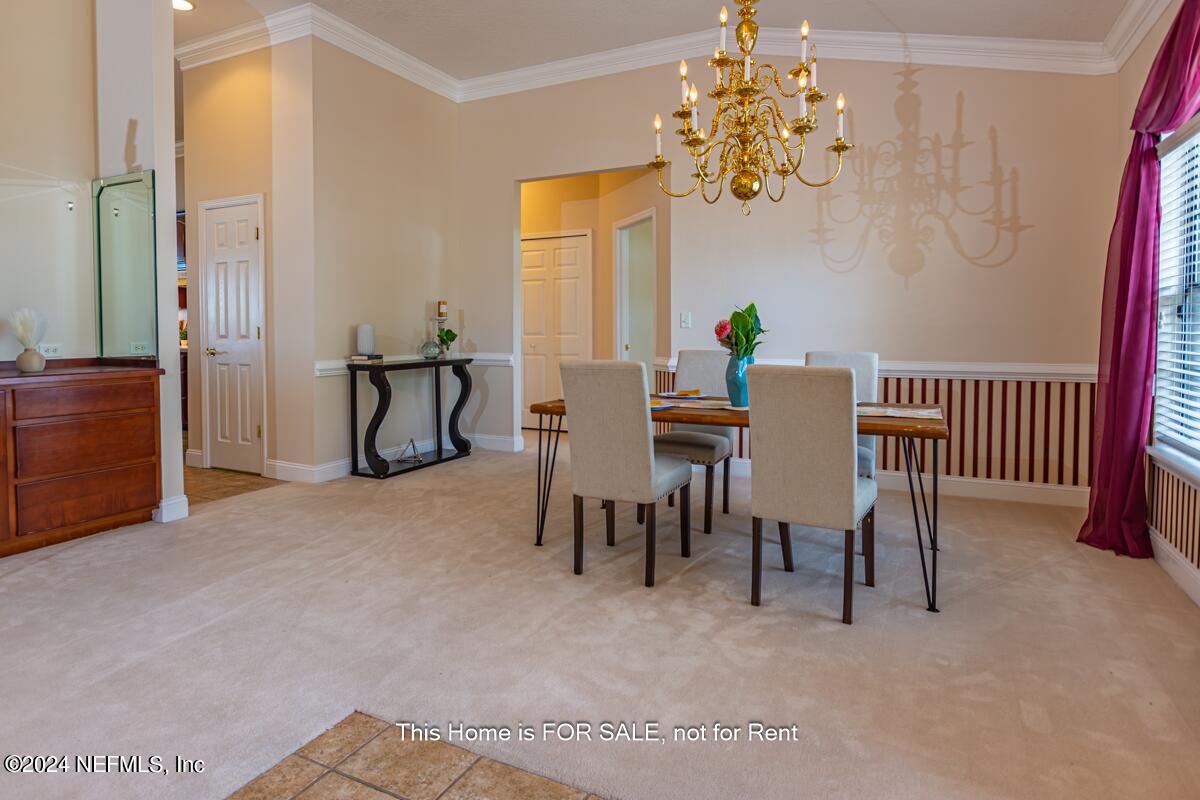5745 Sheffield Road Jacksonville, FL 32226 - Photo 9 of 57 a view of a dining room with furniture and a chandelier