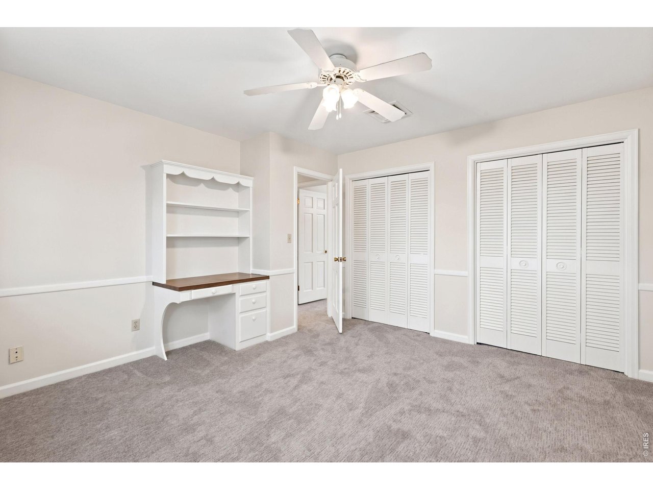 2121 18th Street Road Greeley, CO 80631 - Photo 31 of 40 2nd bedroom features double closets and stylish work station.