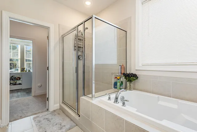 a bedroom with a large bed and a flat tv screen on the dresser