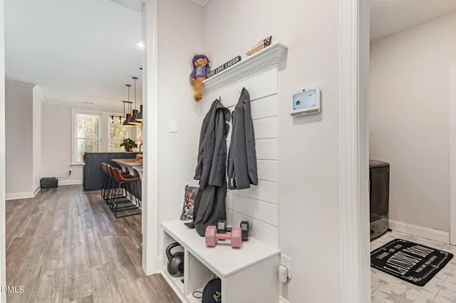 a view of a white house next to a yard and road