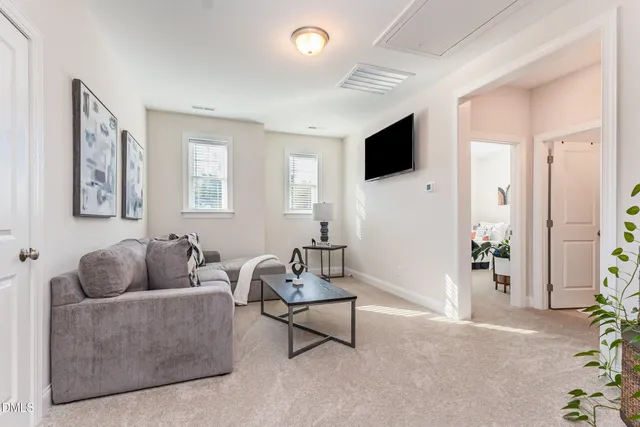 a living room with furniture and a floor to ceiling window