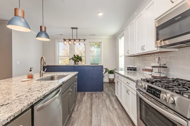 a bedroom with a bed and a white cabinet