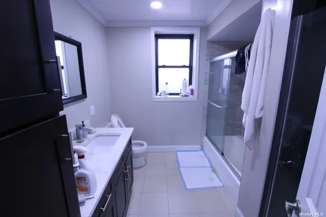 a bathroom with a bathtub sink and mirror
