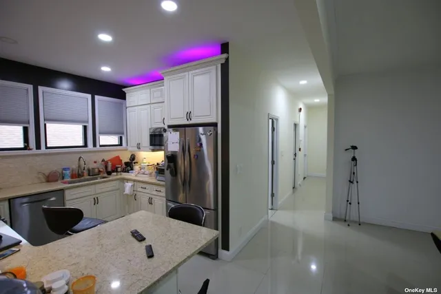 a kitchen with a sink refrigerator and cabinets