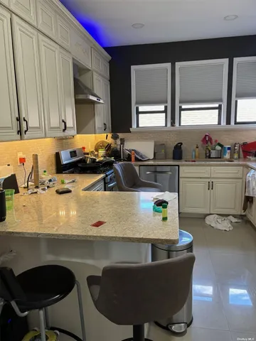 a kitchen with a sink a stove and a cabinets