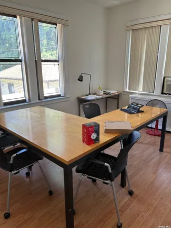 a room with a table chairs and wooden floor