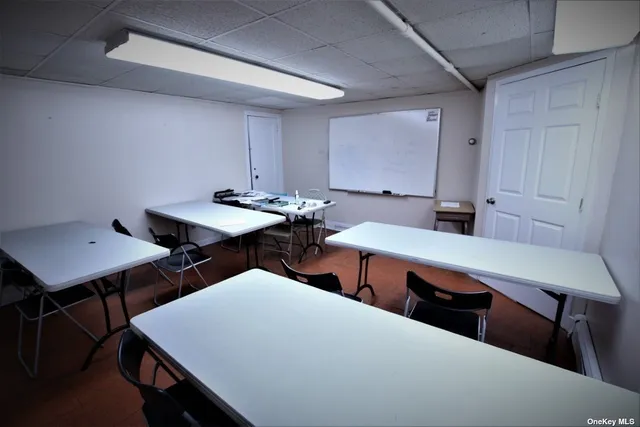 a room with chairs and wooden floor