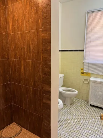 a bathroom with a toilet and a shower