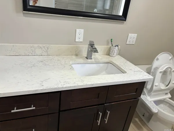 a bathroom with a sink and a mirror