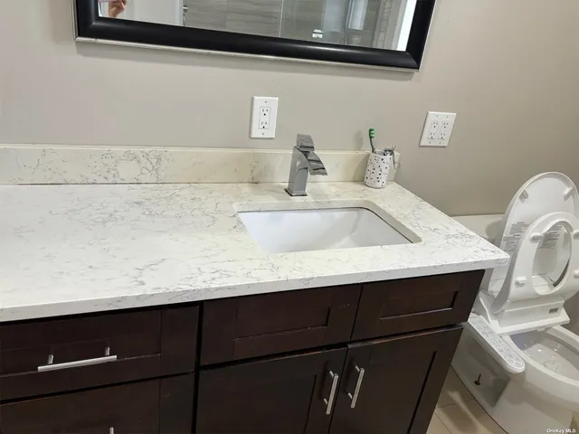 a bathroom with a sink and a mirror