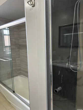 a bathroom with a glass shower door