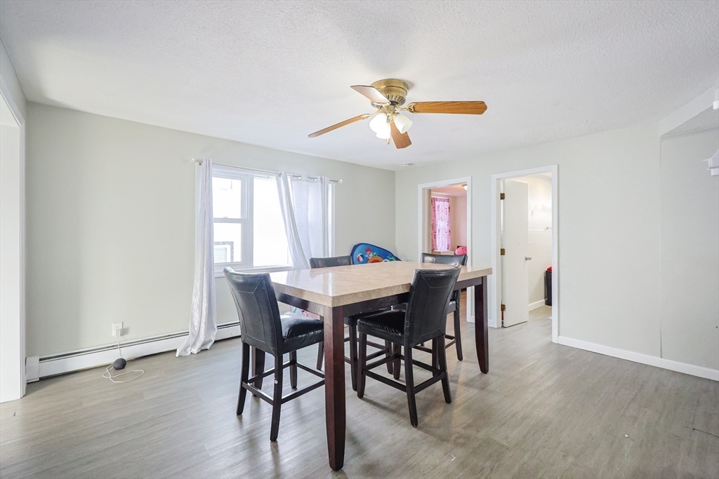 104 Oak Street Fall River, MA 02720 - Photo 13 of 37 a view of a dining room with furniture and wooden floor