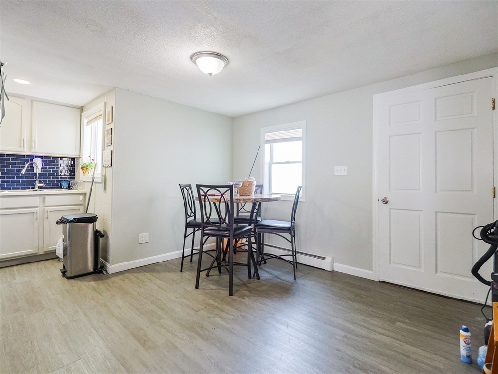 104 Oak Street Fall River, MA 02720 - Photo 17 of 37 a view of a kitchen with dining table and chairs