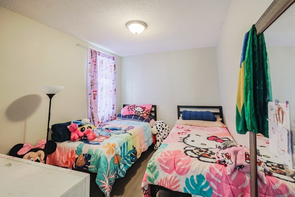 104 Oak Street Fall River, MA 02720 - Photo 18 of 37 a bedroom with a bed and a dresser