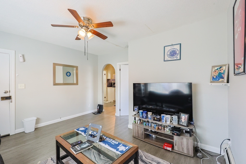 104 Oak Street Fall River, MA 02720 - Photo 22 of 37 a living room with furniture and a flat screen tv