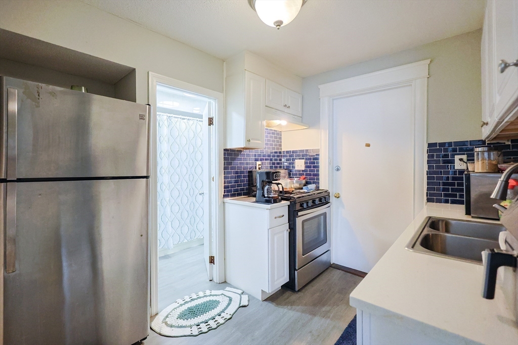 104 Oak Street Fall River, MA 02720 - Photo 24 of 37 a kitchen with a refrigerator and a sink