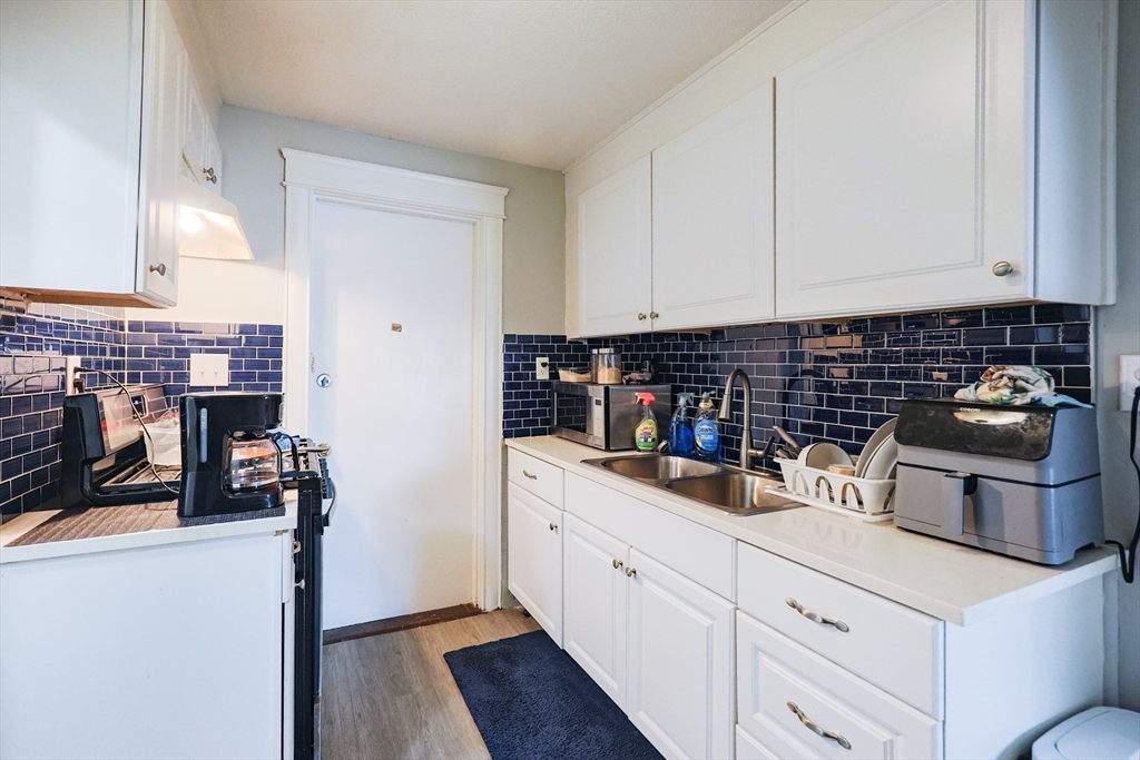 104 Oak Street Fall River, MA 02720 - Photo 25 of 37 a kitchen with a sink and cabinets