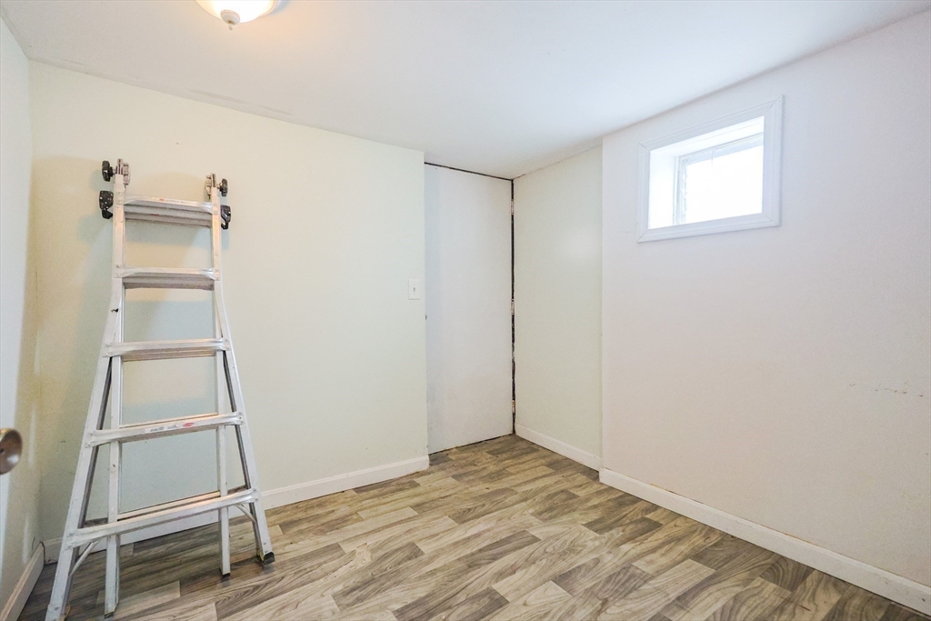 104 Oak Street Fall River, MA 02720 - Photo 28 of 37 a view of an empty room with wooden floor and a window