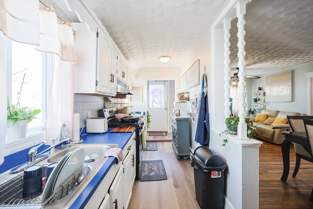 104 Oak Street Fall River, MA 02720 - Photo 9 of 37 a view of a kitchen with furniture and wooden floor