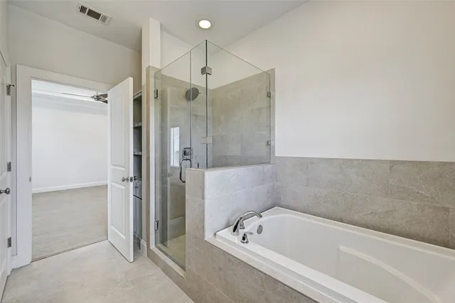 a bathroom with a tub a sink and a shower