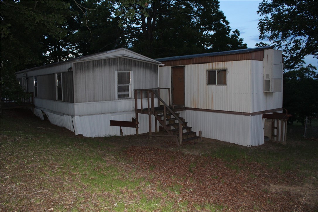 158 Ragon Road Tilly, AR 72679 - Photo 46 of 51 Multi-unit property with a combination of vertical and horizontal siding, multiple entry points, and visible foundation skirting