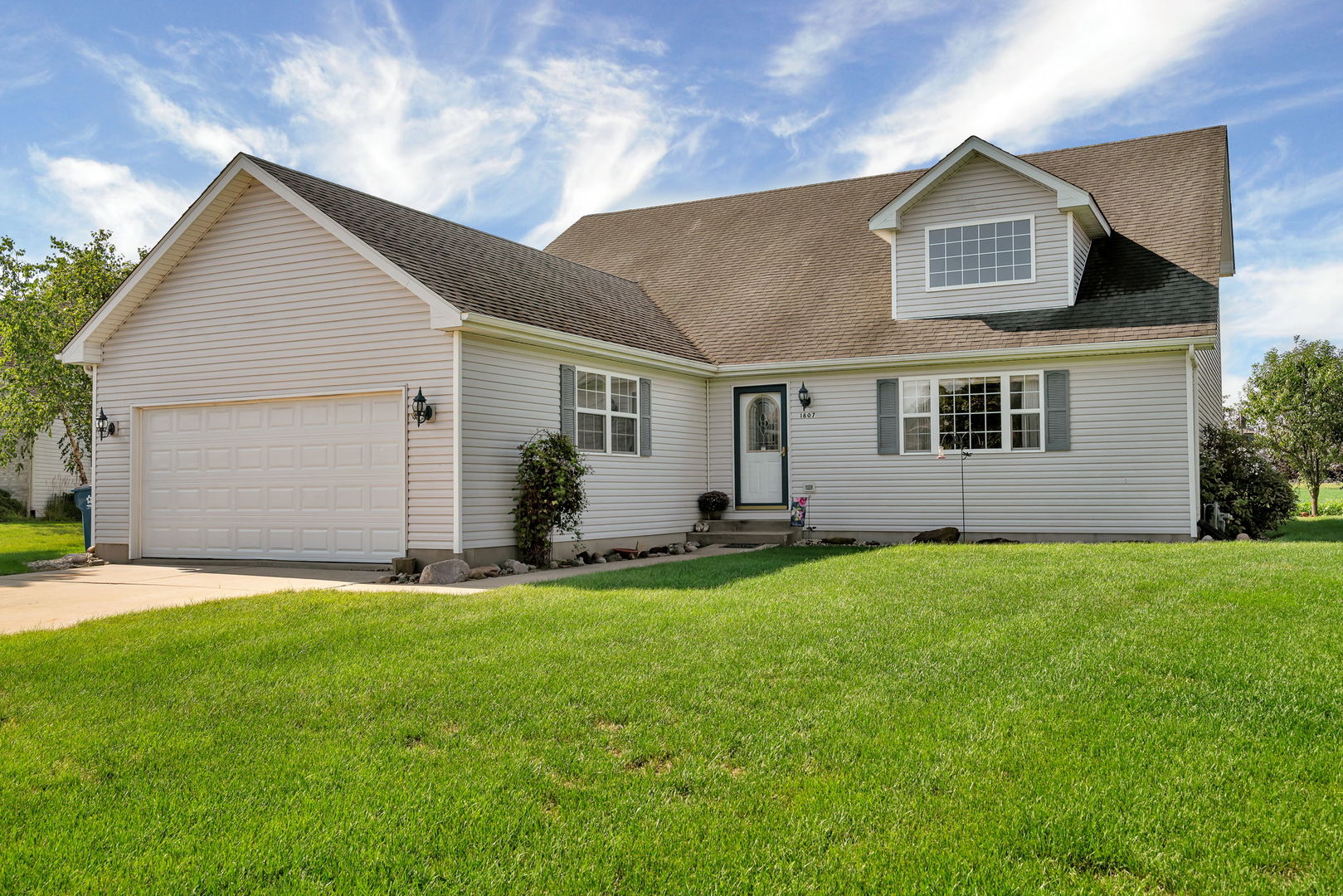a front view of a house with a yard and garage