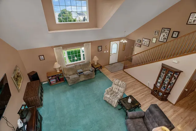 a living room with furniture chess board and a window
