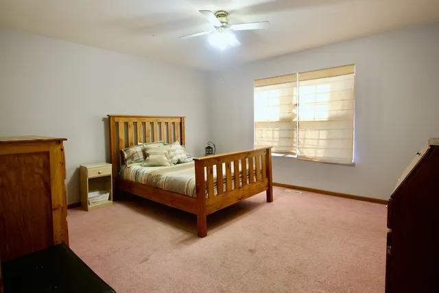 a bedroom with a bed and window